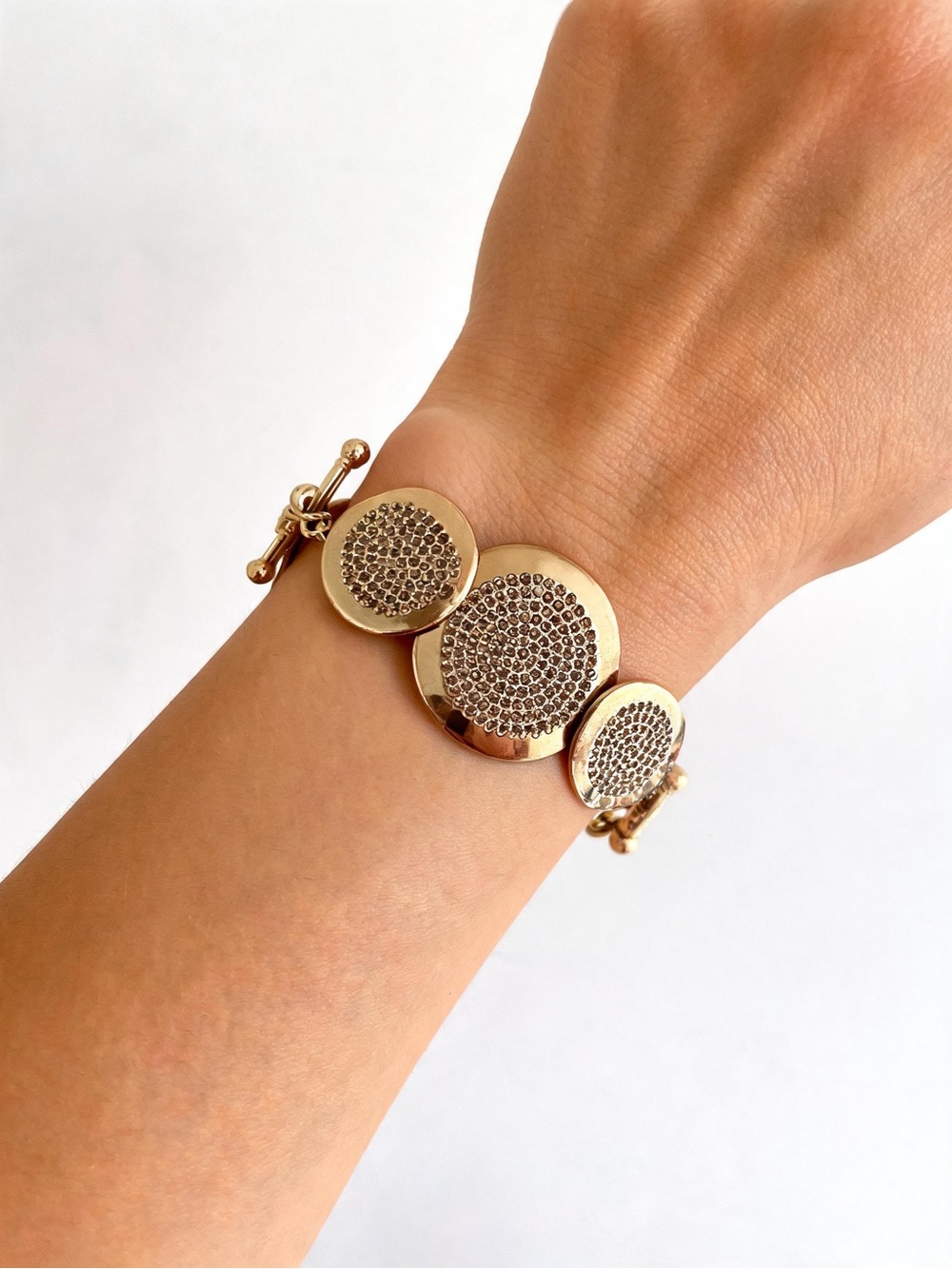 AKKAD gold-tone statement bracelet round, textured medallions with pave crystals
